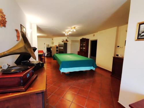 a living room with a bed and a piano at Casa la Buriana in Vinci