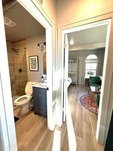 an open door to a bathroom with a toilet and a sink at King Bed Suite-Free Parking-Prime Location in Detroit