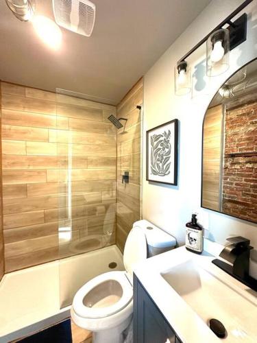 a bathroom with a toilet and a sink at King Bed Suite-Free Parking-Prime Location in Detroit