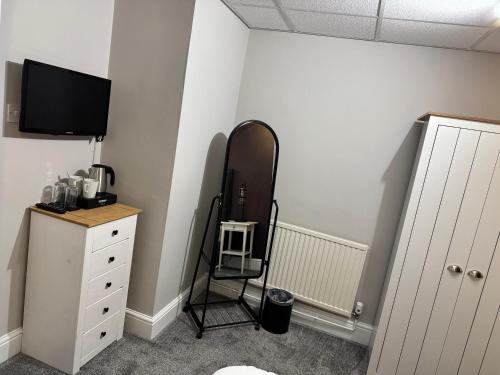 a room with a mirror and a dresser with at New Masons Arms in Leeds