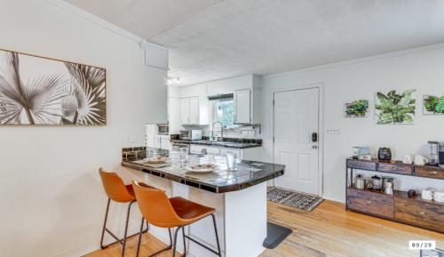 a kitchen with orange chairs and a counter top at Milton Waterfront Home with Dock & Outdoor Kitchen in Milton