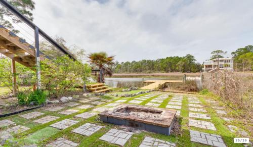 a garden with a pond and a house at Milton Waterfront Home with Dock & Outdoor Kitchen in Milton