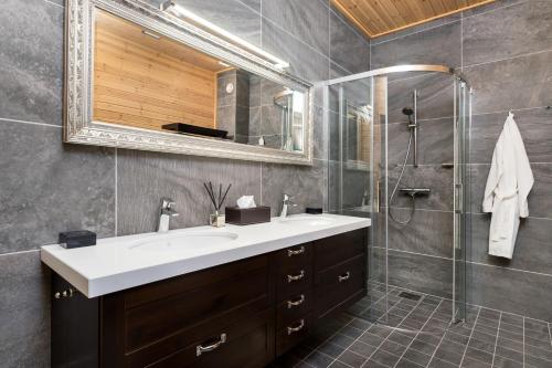 a bathroom with a sink and a shower at Woodland Retreat Lodge in Vallapalu