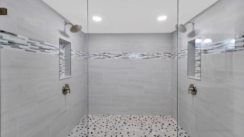 a bathroom with a shower with a glass door at Conch in the Treetops by Last Key Realty in Key West