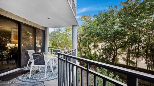 a balcony with a table and chairs on it at Conch in the Treetops by Last Key Realty in Key West