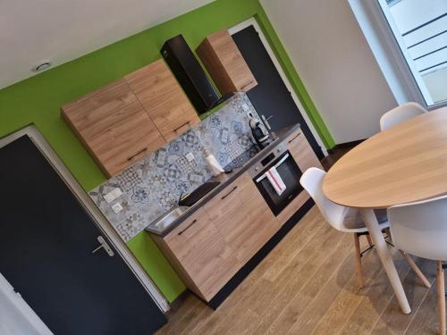 a kitchen with a wooden table and a table and chairs at appartement avec terrasse in Sillery