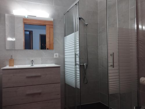 a bathroom with a sink and a glass shower at Casa Seña Catalina, antigua casa típica canaria in La Oliva