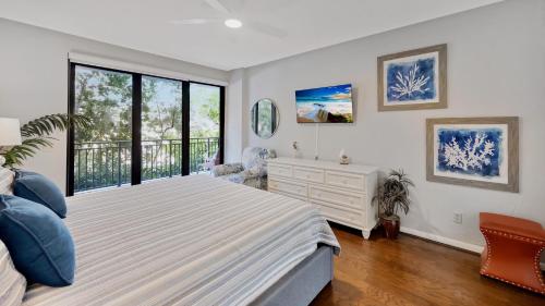a bedroom with a large bed and a window at Conch in the Treetops by Last Key Realty in Key West