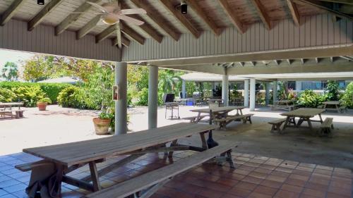 a group of picnic tables on a patio at Conch in the Treetops by Last Key Realty in Key West
