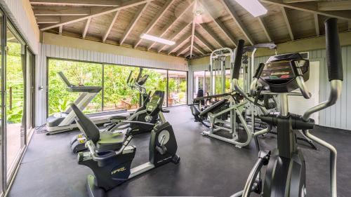 a gym with several treadmills and elliptical machines at Conch in the Treetops by Last Key Realty in Key West