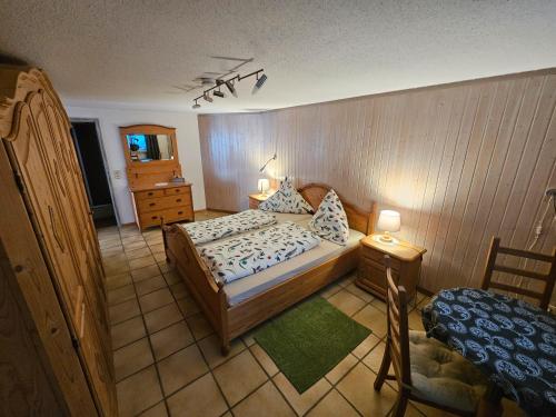 a bedroom with a bed and a dresser and a bed sidx sidx at Ferienwohnungen Golla-lang in Oberharmersbach