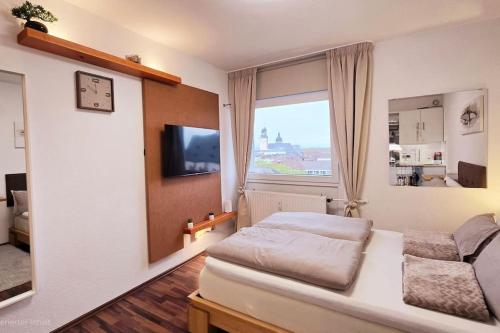 a bedroom with a bed and a large window at City Lage mit Rheinblick in Mainz