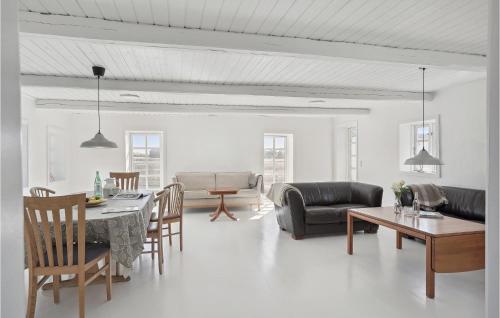 a living room with a table and chairs at Nice Apartment In Gandrup With Kitchen in Gandrup