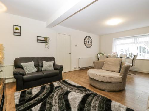a living room with a couch and a chair at Meillion in Aberdare