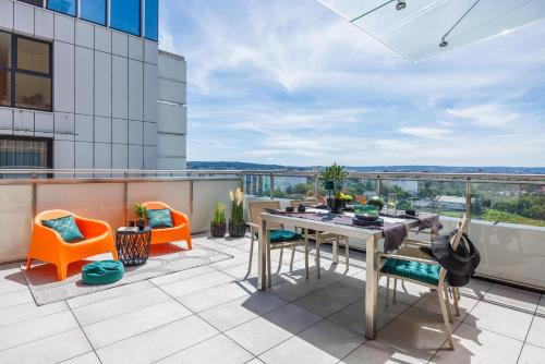 an outdoor patio with a table and chairs on a building at Emihouse Riverside Premium Apartments & Free Parking in Rzeszów