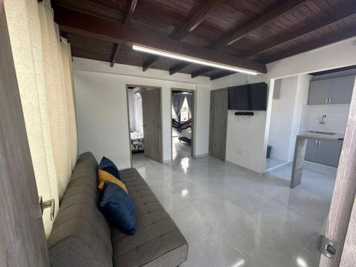 a living room with a couch and a kitchen at Apartamento Bahía de Santa marta in Santa Marta