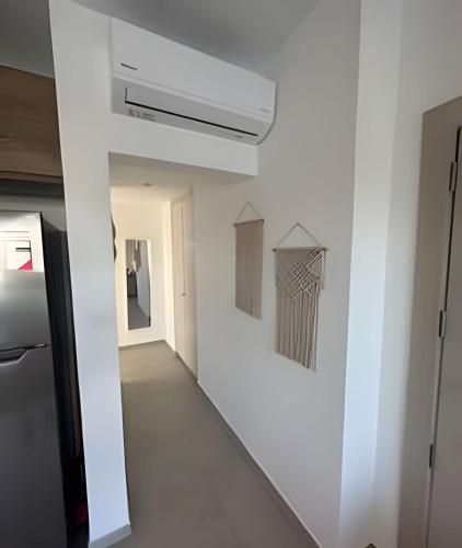a hallway with white walls and a white ceiling at Estrella Dominicus Advantage in Bayahibe