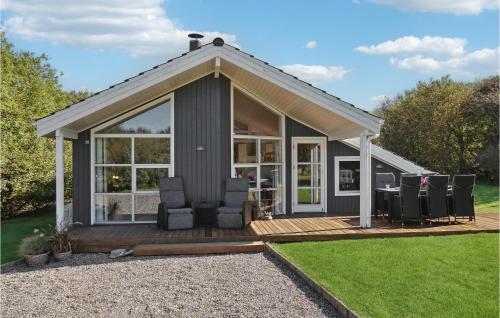 a small house with a deck and chairs at Amazing Home In Vestervig With Kitchen in Vestervig