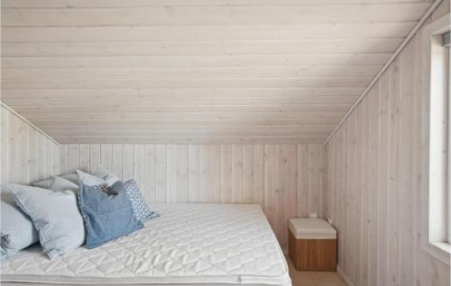 a bed in a room with a wooden ceiling at Amazing Home In Vestervig With Kitchen in Vestervig