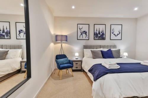 a bedroom with a bed and a chair and a mirror at Cosy, Exclusive Sheffield House near Peak district in Sheffield