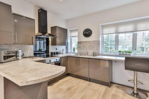a large kitchen with a large island in the middle at Cosy, Exclusive Sheffield House near Peak district in Sheffield