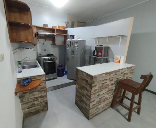 a kitchen with a counter and a sink and a stove at Departamento Yavari in Iquitos