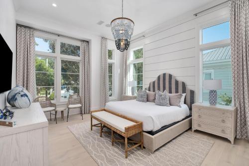 une chambre avec un lit, une chaise et des fenêtres dans l'établissement Bearfoot By The Sea, à Santa Rosa Beach