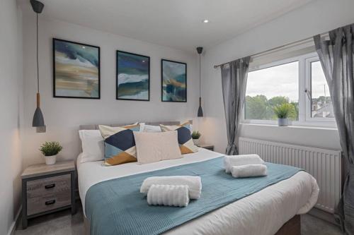 a bedroom with a large bed with two pillows on it at Prime Location, Modern 2br House in Sheffield