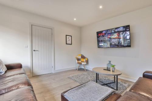 a living room with a couch and a table at Modern, Cosy Whole house WiFi close to attractions in Sheffield