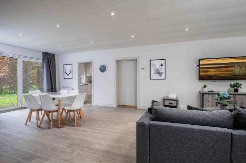 a living room with a couch and a table and chairs at 3 BR Bungalow close to Peak District with Garden in Sheffield