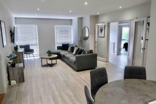 a living room with a couch and a table at 3 BR Bungalow close to Peak District with Garden in Sheffield
