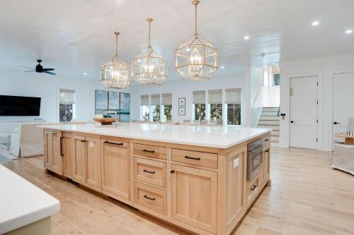 a kitchen with a large island with white counter tops at Shore To Have Fun in Seagrove Beach