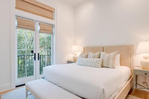 a white bedroom with a bed and a window at Shore To Have Fun in Seagrove Beach