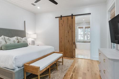 a bedroom with a bed and a television and a tub at Shore To Have Fun in Seagrove Beach