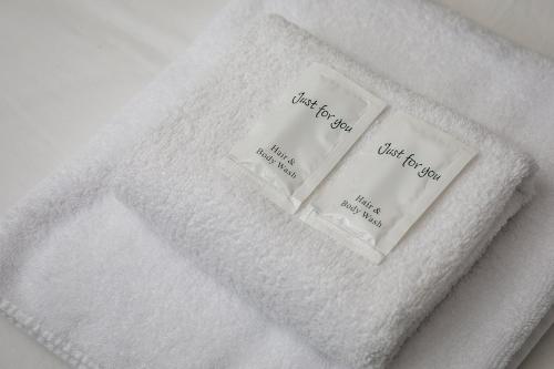 three towels sitting on top of a white towel at 3 Bed Refurbished, Modern House, Wifi, Patio Area in Sheffield