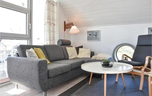a living room with a couch and a table at Holiday Home Ringkøbing With Fireplace Ii in Ringkøbing