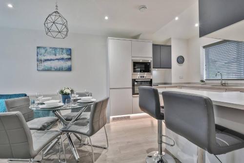 a kitchen and dining room with a table and chairs at Magnificent, renovated whole house with garden in Sheffield