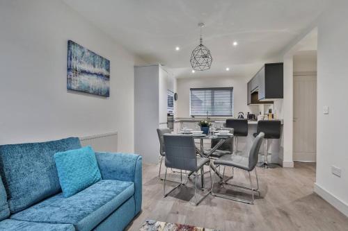 a living room with a blue couch and a table at Magnificent, renovated whole house with garden in Sheffield