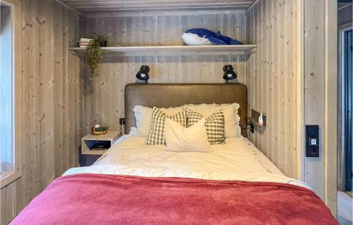a bed in a room with a wooden wall at Gorgeous Home In Gålå With Sauna in Gålå