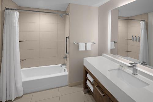 a bathroom with a tub and a sink and a shower at Residence Inn by Marriott Durham Duke University Medical Center Area in Durham