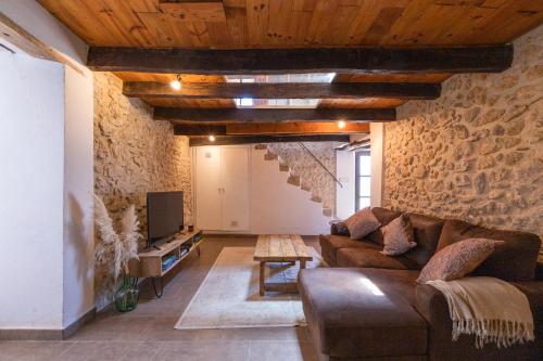 a living room with a couch and a tv at Mas El Casot 1 in Vilademuls