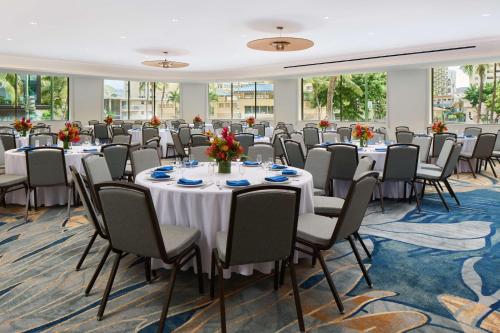 a conference room with long tables and chairs at OUTRIGGER Waikiki Paradise Hotel in Honolulu