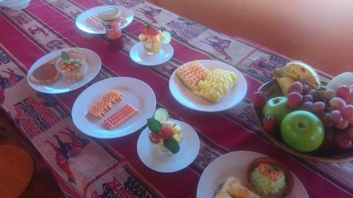 a table with plates of food on a table at Casa de Primo in Puno