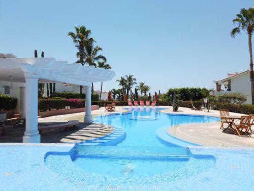 a large swimming pool with a pavilion in a resort at Cabo Cottage Villa Neptuno Charming Villa in Cabo Quiet View Ocean Community in Cabo San Lucas