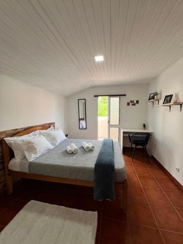 a bedroom with a bed with two towels on it at Quiet Cozy Apt MQ2 & Near Beach & Mountain View in Calheta