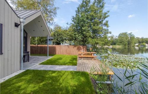 a backyard with a picnic table and a lake at Lovely Home In Oosterwolde With Wifi in Oosterwolde