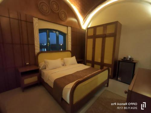 a bedroom with a bed and a window at Aro Kato Nubian Guest House in Aswan