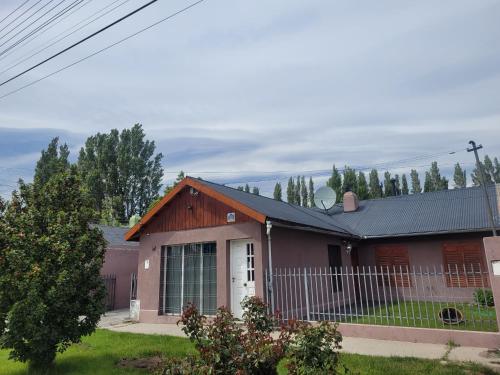 a red house with a black roof at Avenida Centro in Los Antiguos