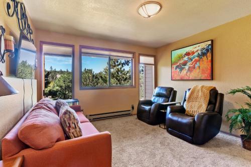 a living room with a couch and two chairs at Multiple Decks, Solarium Sitting Room, Dog Friendly, Office Space in Woodland Park