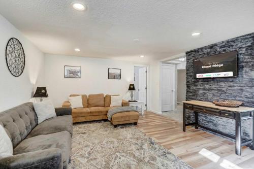 a living room with a couch and a tv at Cloud Ridge Cozy Suite w Fire Pit & Game Area in Colorado Springs
